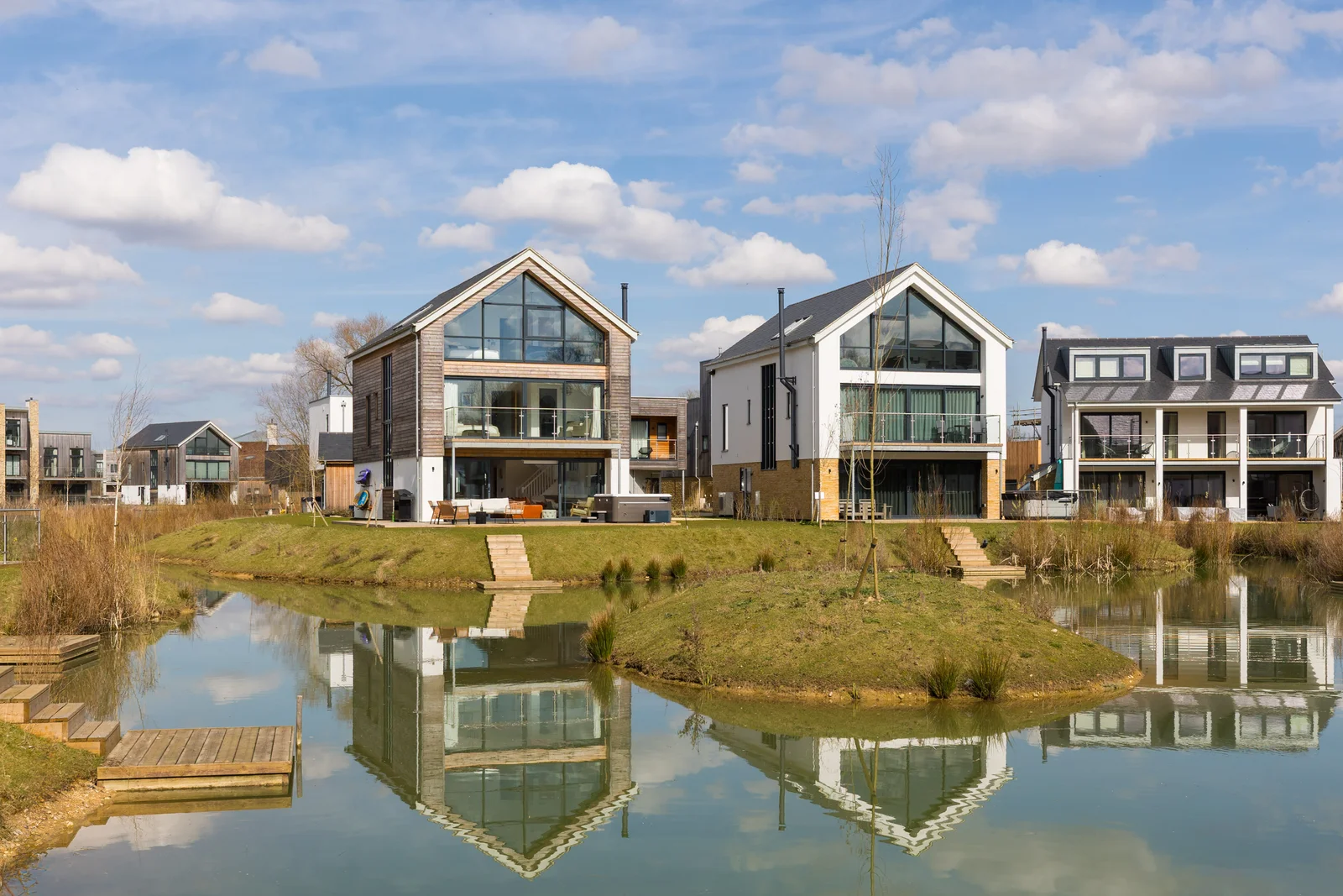 Row of lakeside houses reflected in still water