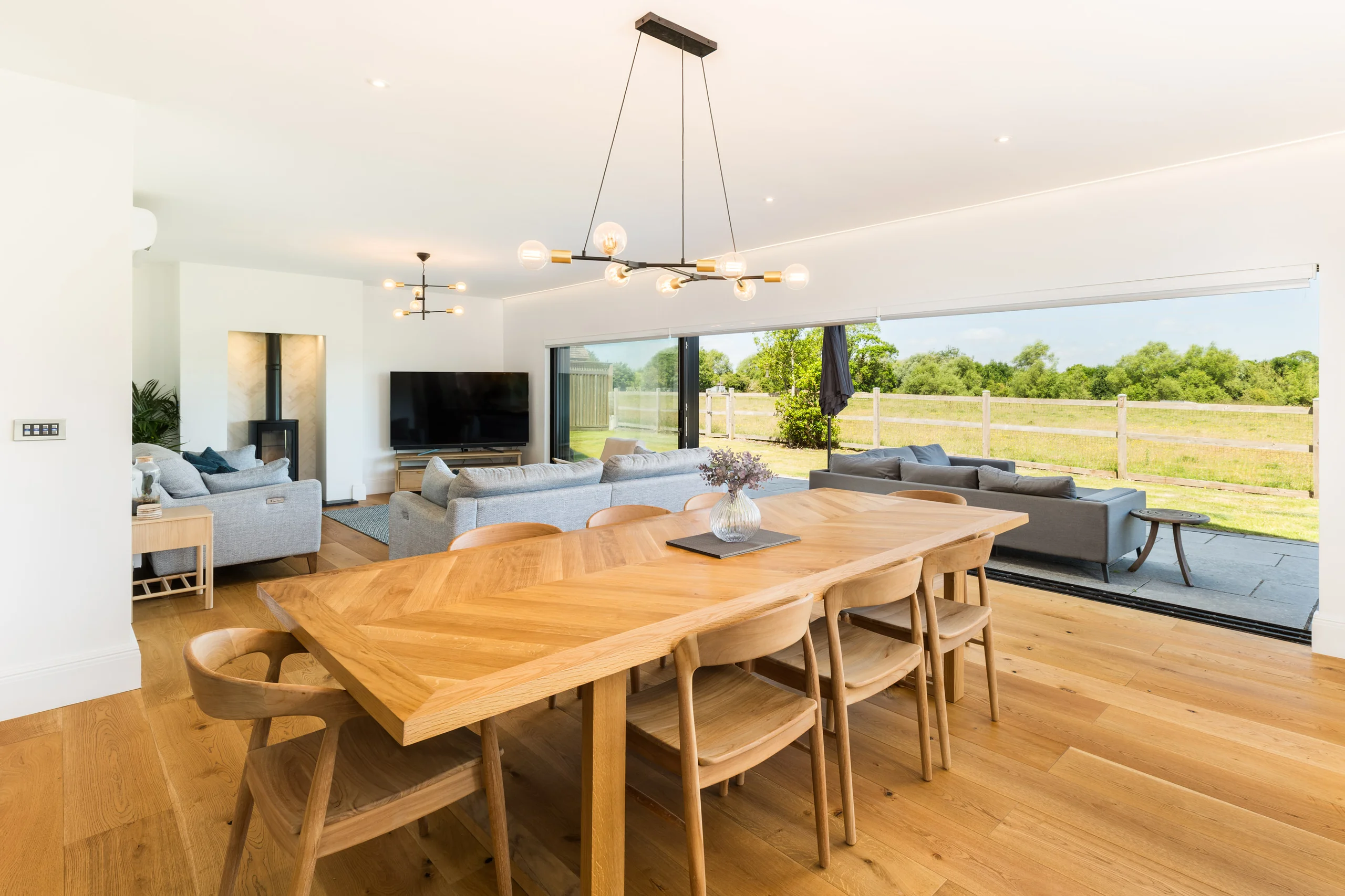 Open plan dining space with full height glazing looking onto open countryside