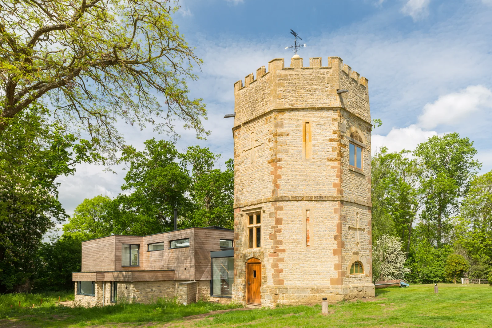 Historic stone folly tower with contemporary timber clad extension