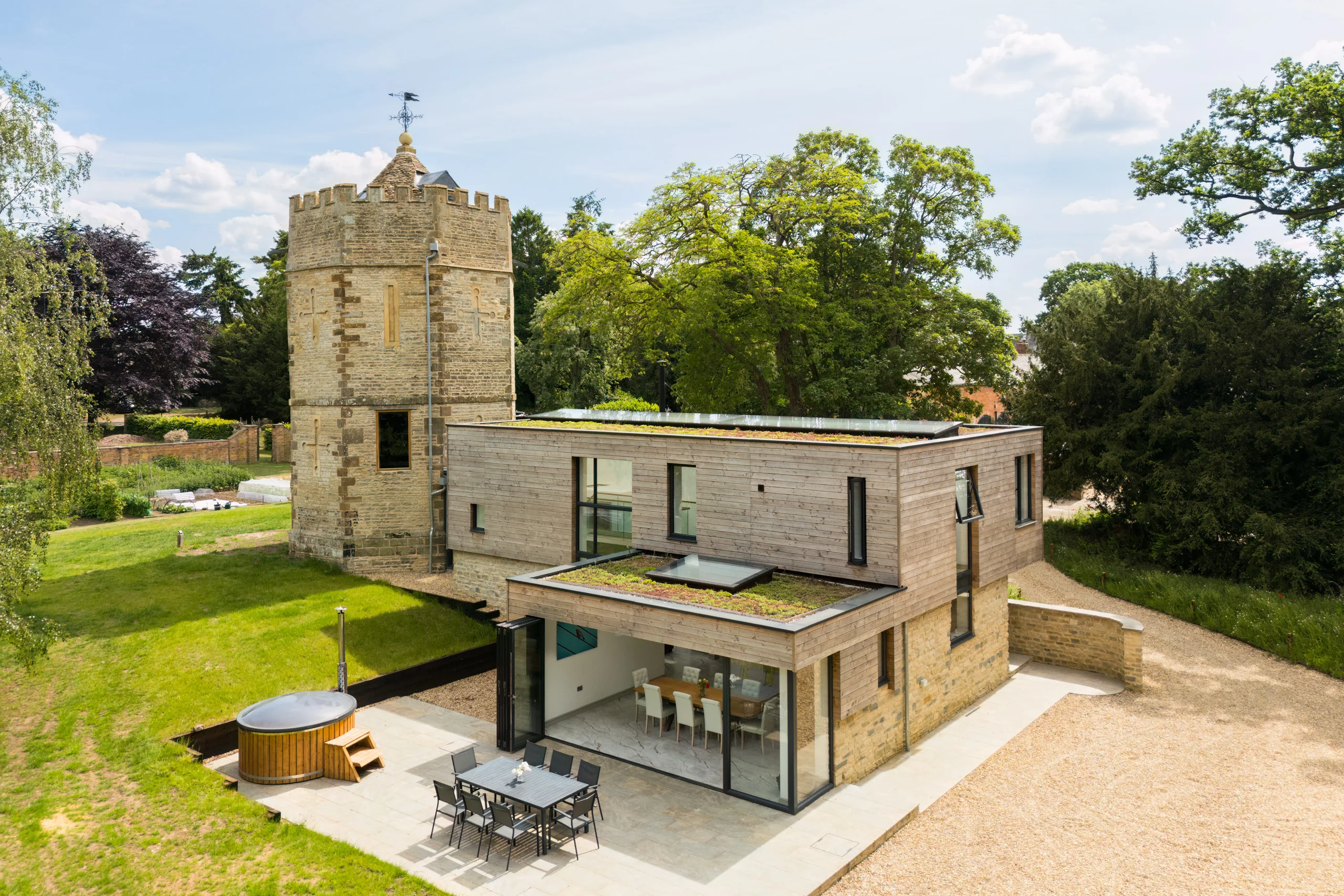Aerial elevation of the folly tower and its contemporary extension in parkland