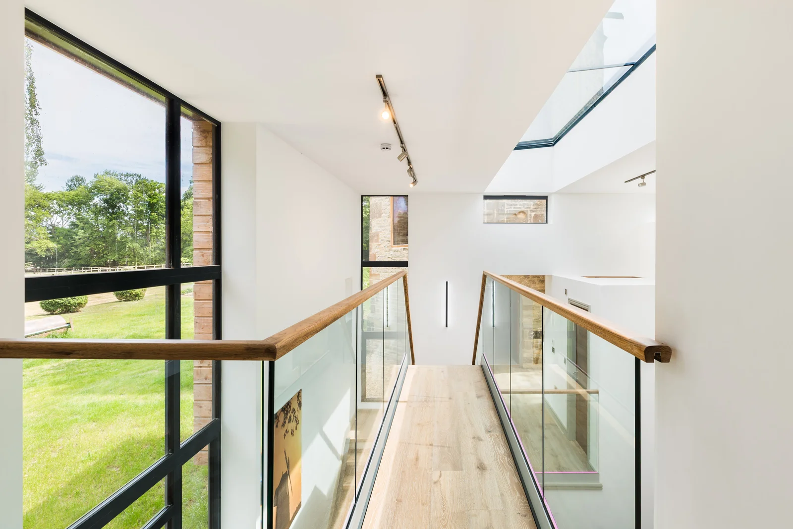Glazed first floor landing with rooflights running toward the garden