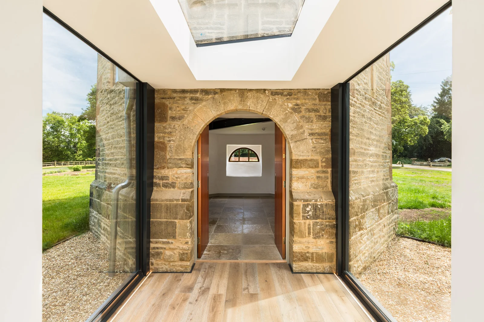 View on axis through the stone archway linking the folly tower and extension